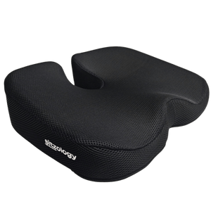 A black cushion designed for ergonomic support, featuring a textured surface and a cutout in the center for seating.